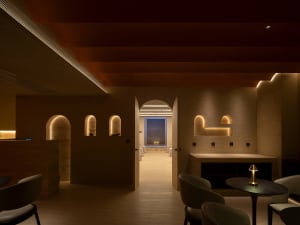 A modern spa interior with brick walls and arched lighting niches.