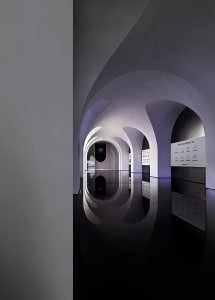 A modern architectural interior design with reflective surfaces and symmetrical arches.