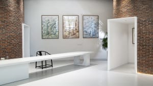 White concrete gallery interior with modern furniture and abstract art displays.