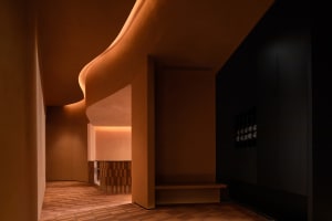 A contemporary spa interior with modern concrete elements and curved lighting.