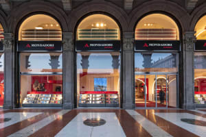 Modern bookstore storefront with glass and concrete architectural elements.