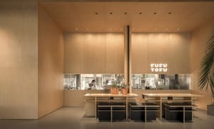 Industrial design restaurant interior with wooden walls and tables.