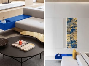 A modern living room featuring a blue accent tile floor accompanied by a minimalist sofa and a round coffee table with a book