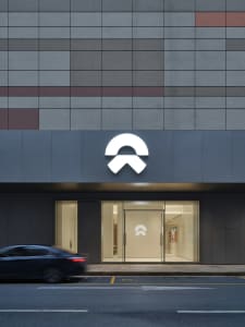 Modern storefront with a glass entrance, concrete facade, and metal elements.