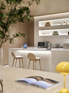 Modern design coffee shop featuring a terrazzo countertop and stools.