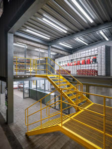 A modern industrial logistics center with metal and glass features for efficient material handling and storage.