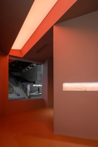 A minimalist interior space featuring concrete walls and floors.