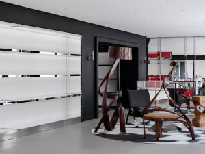 A modern lobby featuring sleek wooden and metal furniture with a glass element, set against a black and white geometric patte