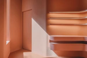 A modern staircase with metallic steps and handrails, featuring a sleek and contemporary design.