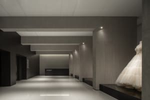 A modern retail storefront with concrete walls and white flooring.