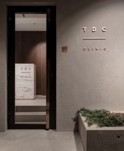 A modern clinic entrance with concrete stairs and marble accents.