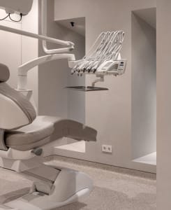 White leather dentist's chair and metal equipment in a modern dentist office