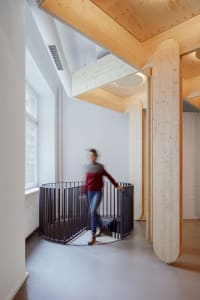 A modern industrial residential interior with wooden elements.
