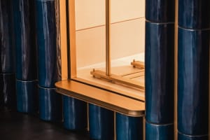 A modern interior space featuring metallic tubing columns.