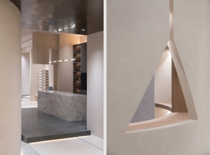 A modern interior design featuring concrete walls and marble surfaces.