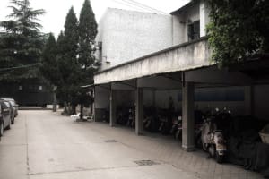 Industrial building exterior with concrete walls and a large canopy.