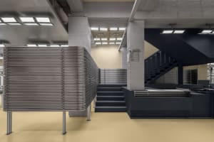 A spacious, industrial-style lobby featuring metal columns and modern design elements.