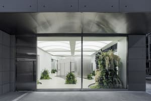 Modern office space featuring glass walls and contemporary design elements.
