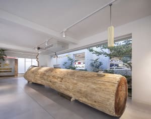 A modern reception desk made of wood in a lobby setting.