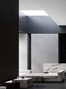 Contemporary living room featuring marble, concrete, and leather materials.