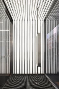 A modern interior space featuring metallic columns and vertical lines.