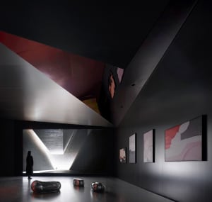 A modern interior design of a lobby with concrete walls and a high ceiling.
