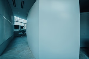 Modern office with a curved concrete wall.