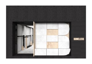 A minimalist retail storefront with a concrete facade, featuring the word 'BONELESS' in wooden letters.