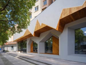 A modern storefront with a combination of wood and concrete materials.