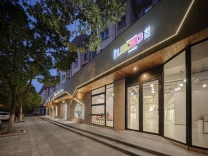Modern commercial storefront with neon lighting and fiberboard exterior