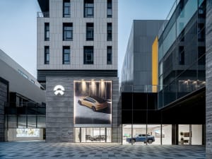 Modern auto dealership with glass exterior and showroom interior.