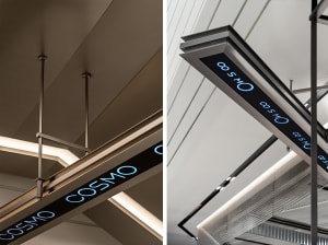 Industrial-style metal signage reading 'COSMO' mounted on a ceiling.