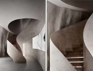 An image of a modern, spiral staircase made of concrete.