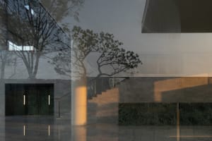 Modern lobby interior featuring concrete walls and marble floor.
