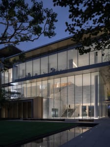 A modern office building exterior made of glass and concrete.