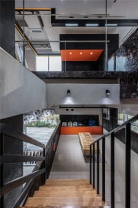 Interior design featuring a modern commercial space with concrete walls, marble accents, and wooden elements.