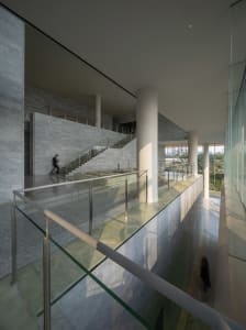 Modern interior space featuring glass and marble materials.