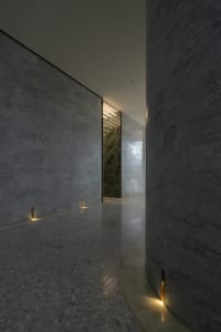 Modern interior with a corridor featuring a moody lighting setup.