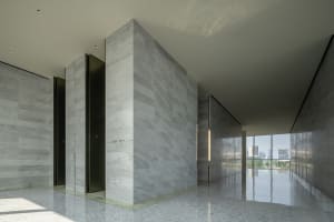 A modern marble lobby interior with minimalist design and sleek, polished finishes.
