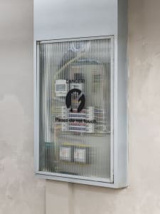 Industrial-style electrical cabinet with a sign that reads 'DANGER! Please do not touch.'