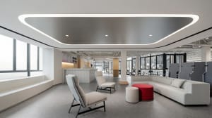 Modern office space featuring neutral-colored furnishings and seating arrangements.