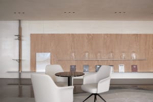 Minimalist interior design featuring modern wood, leather, and glass materials.