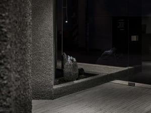 Minimalist lobby interior featuring polished concrete floors and glass details.