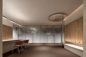 A modern reception area featuring a clean, minimalist design with natural wood accents.