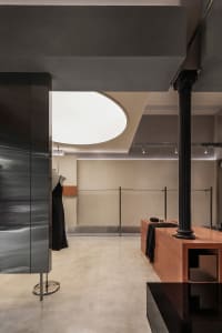 Modern minimalist clothing shop interior with metal and wood accents