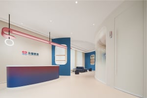 A modern commercial interior featuring a sleek, multi-colored reception desk with a contemporary design.