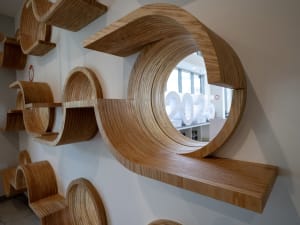 Circular wooden shelves on a wall, providing unique storage solutions.
