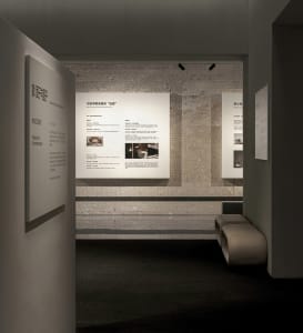 A well-lit interior design exhibit displaying detailed information and photographs on paper.