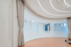 Modern hospitality design featuring large, transparent glass panels and minimalist decor.