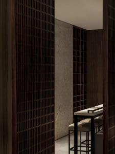 Modern restaurant bar with wood and concrete materials and high-top seating